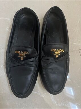 Prada Black Leather Slip-On Loafers with Gold Logo